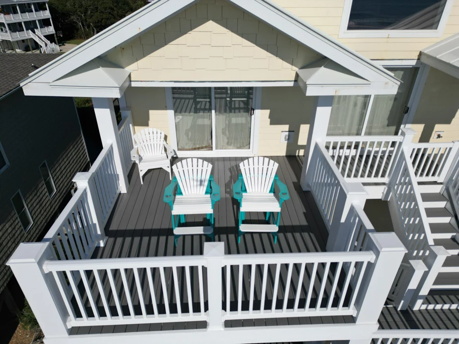 Aerial view of composite deck with three chairs and white railing