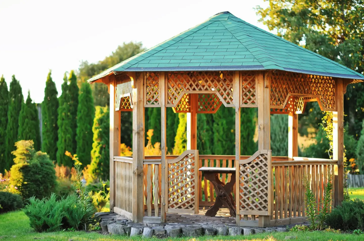 Close up view of the outdoor wooden gazebo over summer landscape background