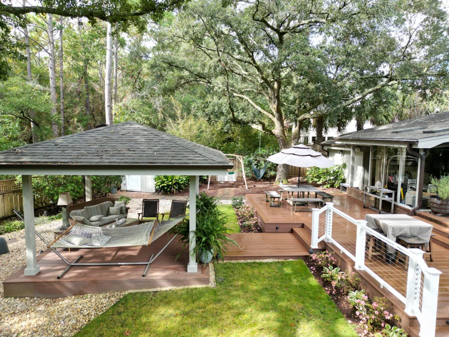 Composite brown deck with white railing featuring gazebo and outdoor living furniture