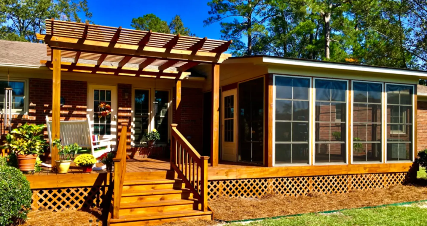 Custom pergola on the deck with skirting and a screened porch beside it in wilmington nc
