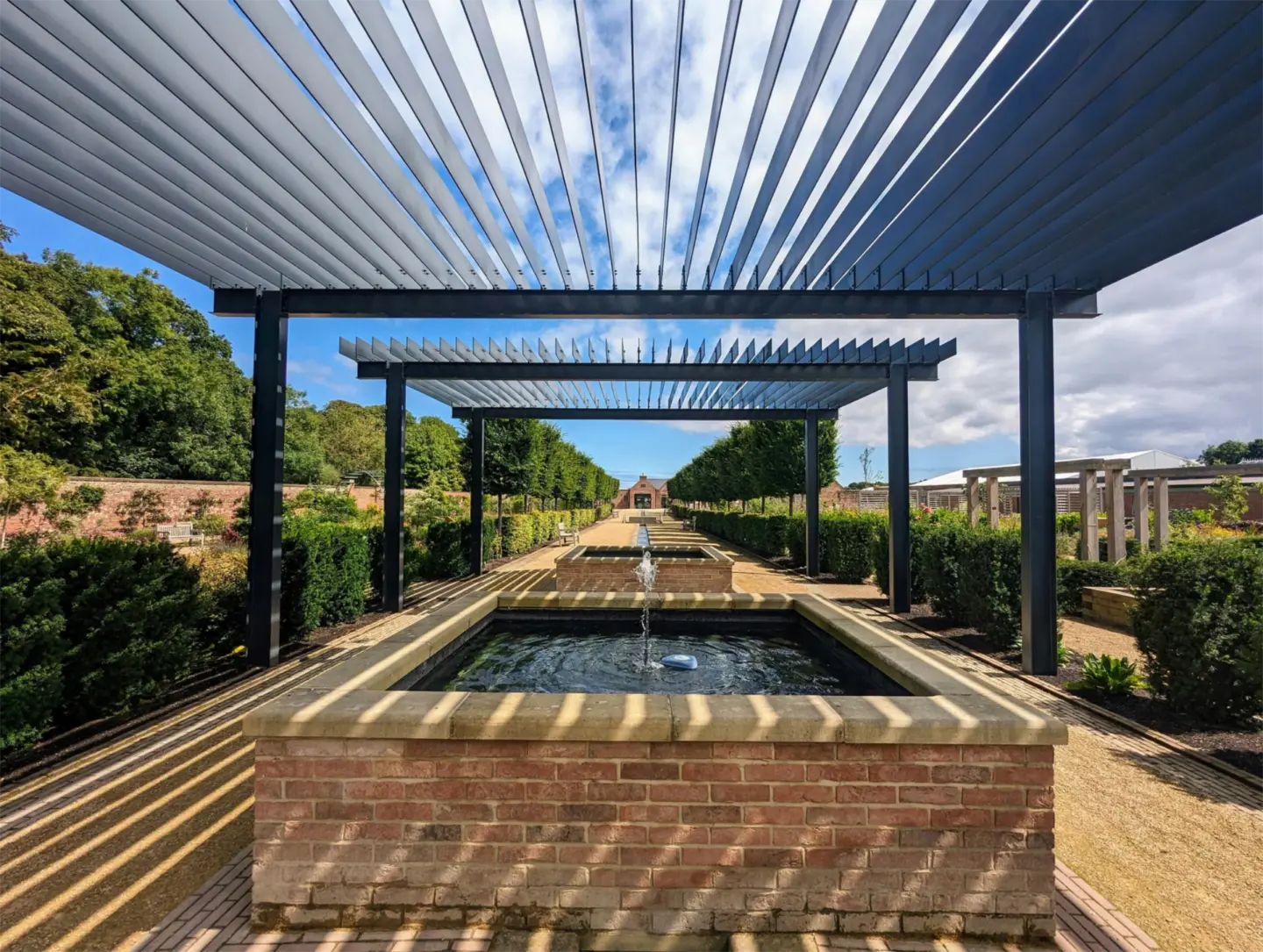 Elegant garden louvered pergola with small fountain in wilmington nc