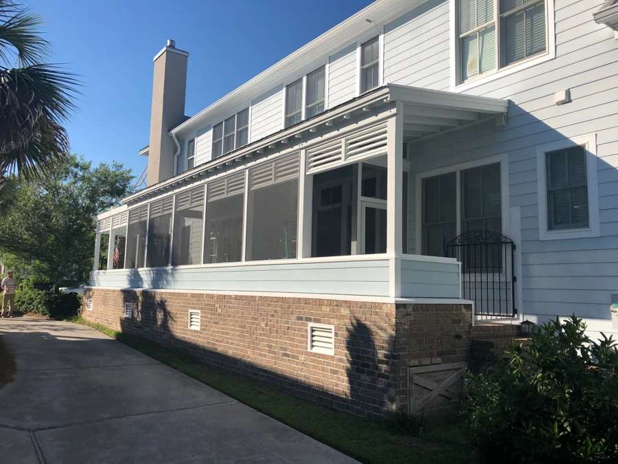 Long screened porch with a black metal gate in wilmington nc