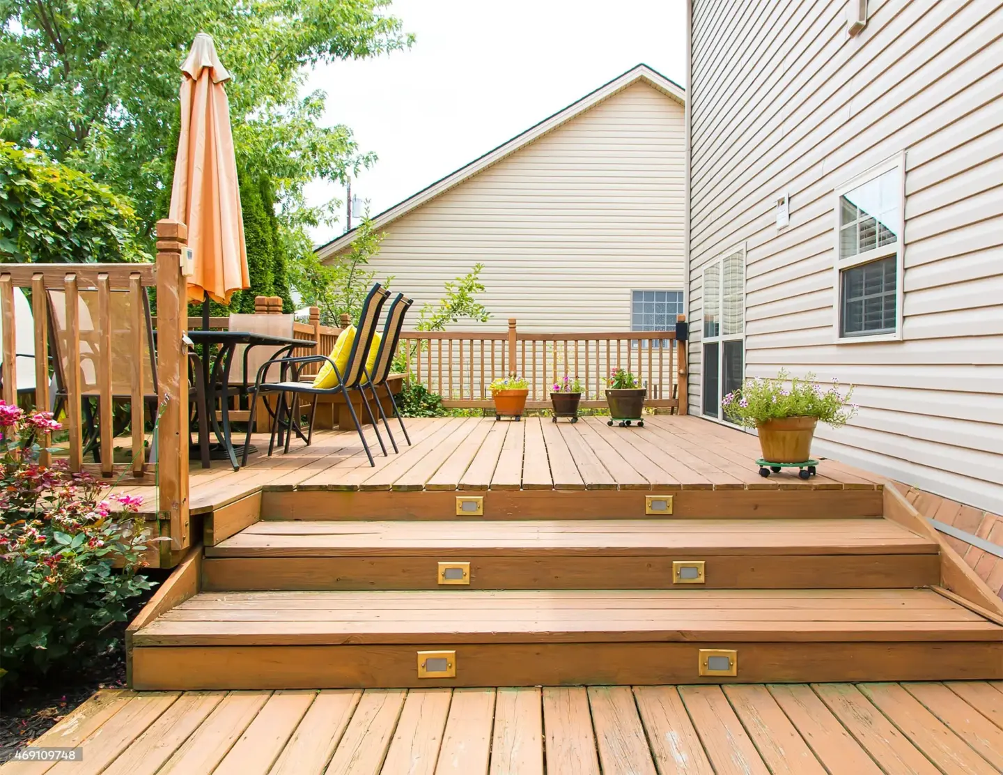 Outdoor deck with lights on stairs steps with outdoor living furniture