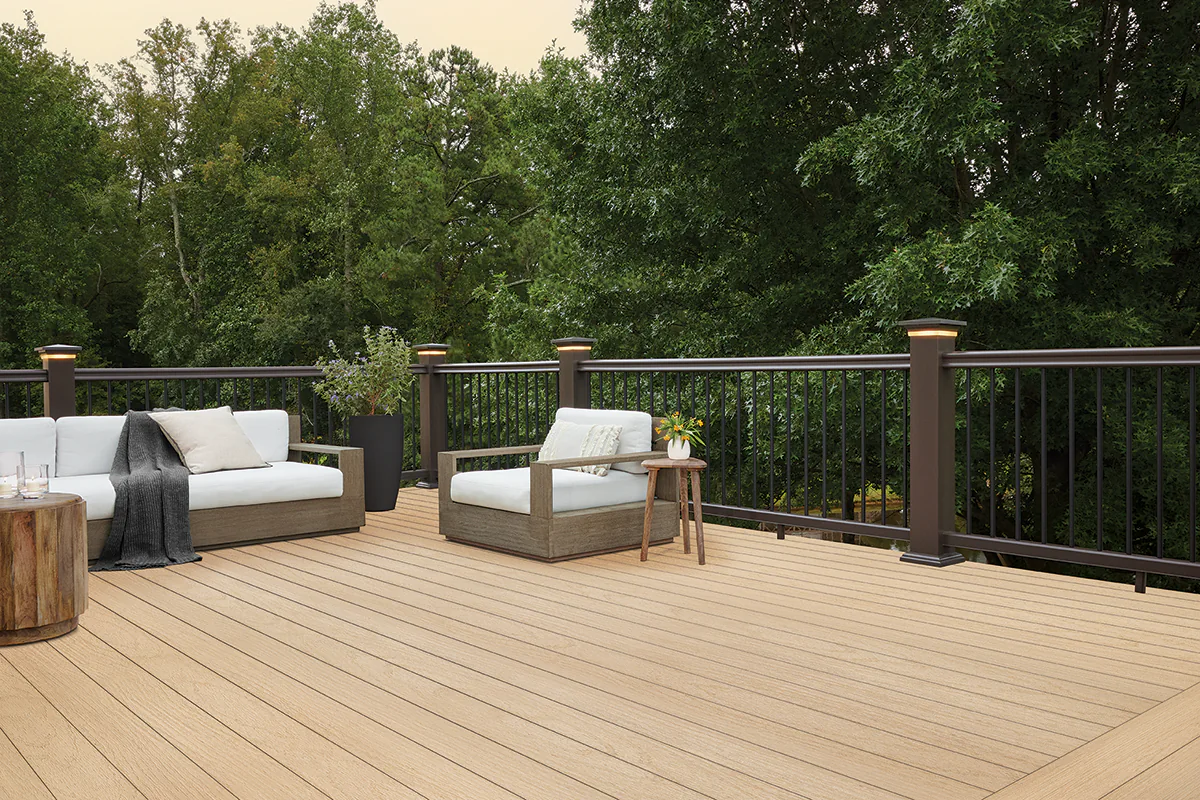 Pvc harvest plus toasted wheat decking with outdoor living furniture featuring trees on the background