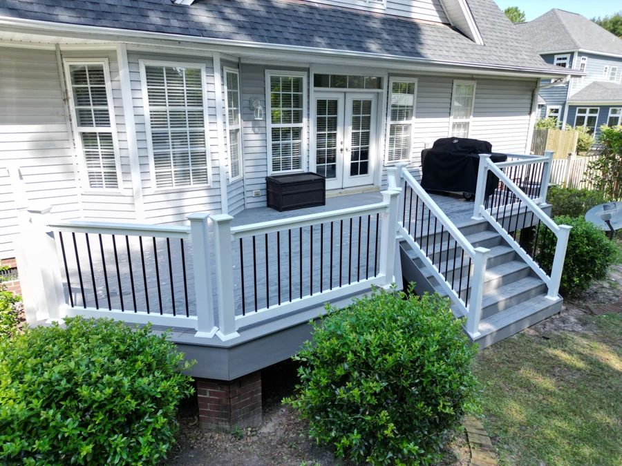 Raised commercial deck with black and white railing with covered porch on the wilmington