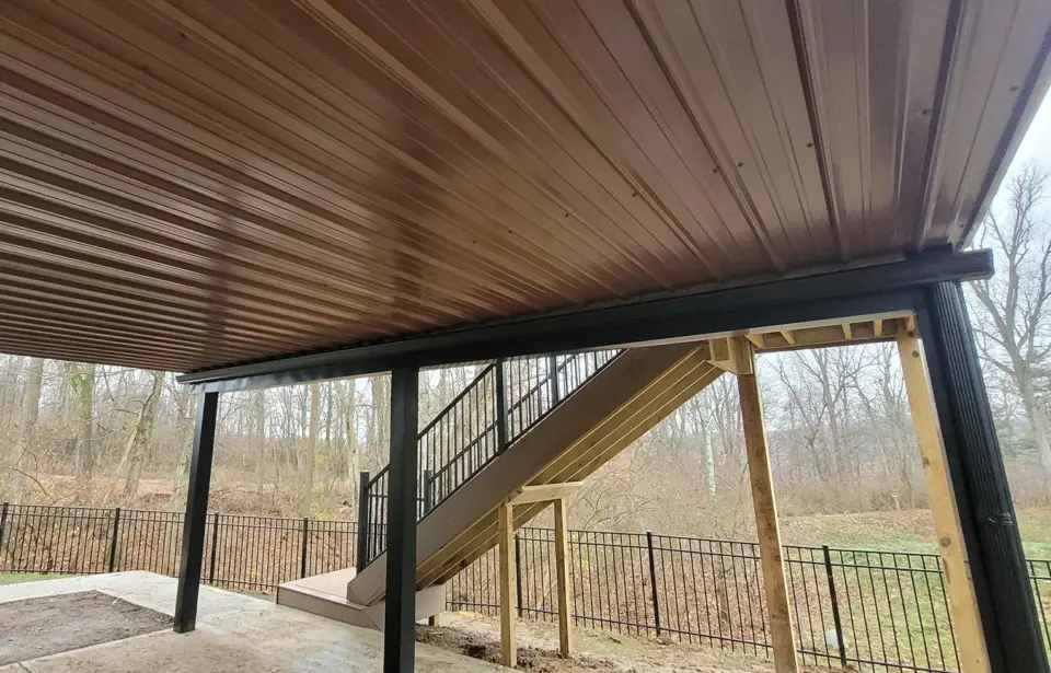 Under deck view with black metal fence on the wilmington